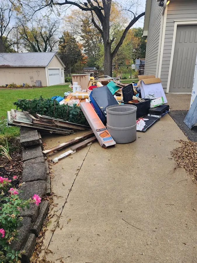 Dumpster being loaded with debris for Commercial Dumpster Rental in Eastpointe
